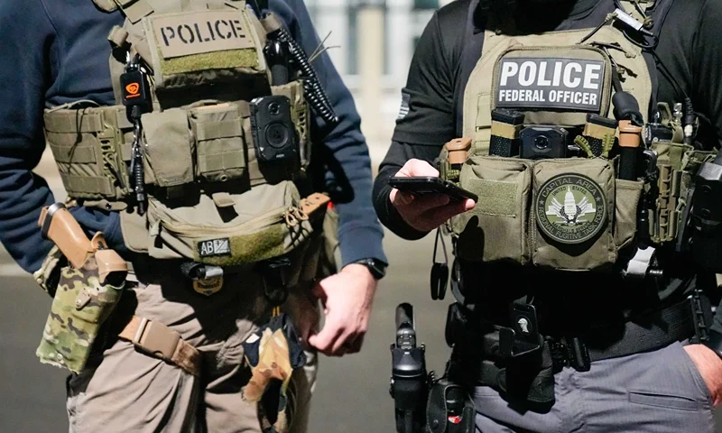 WASHINGTON, DC - FEBRUARY 4: In this handout photo provided by U.S. Immigration and Customs Enforcement, two federal law enforcement officers coordinate with other officials on the ground during an enhanced immigration enforcement operation on February 4, 2025 near Washington, D.C. (Photo by U.S. Immigration and Customs Enforcement via Getty Images)