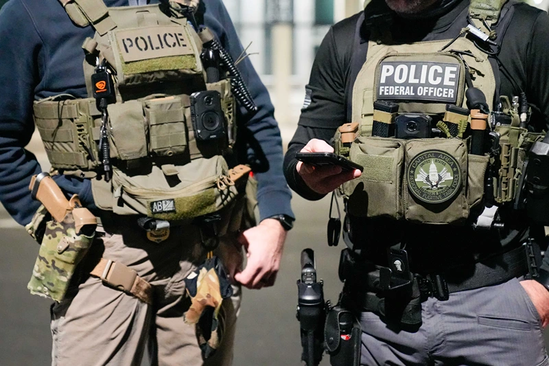 WASHINGTON, DC - FEBRUARY 4: In this handout photo provided by U.S. Immigration and Customs Enforcement, two federal law enforcement officers coordinate with other officials on the ground during an enhanced immigration enforcement operation on February 4, 2025 near Washington, D.C. (Photo by U.S. Immigration and Customs Enforcement via Getty Images)