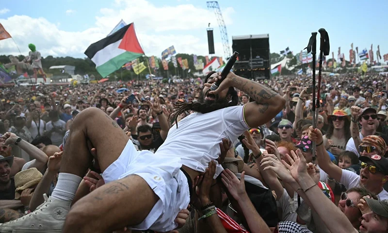 Bobby Vylan of British duo Bob Vylan crowd surfing while performing on the West Holts Stage on the fourth day of the Glastonbury festival at Worthy Farm in the village of Pilton in Somerset, south-west England, on June 28, 2025. (Photo by Oli SCARFF / AFP) (Photo by OLI SCARFF/AFP via Getty Images)