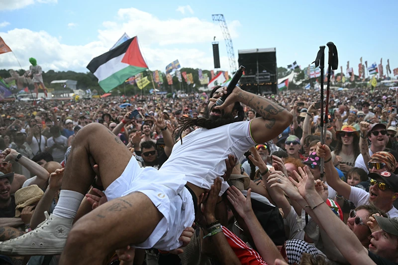 Bobby Vylan of British duo Bob Vylan crowd surfing while performing on the West Holts Stage on the fourth day of the Glastonbury festival at Worthy Farm in the village of Pilton in Somerset, south-west England, on June 28, 2025. (Photo by Oli SCARFF / AFP) (Photo by OLI SCARFF/AFP via Getty Images)