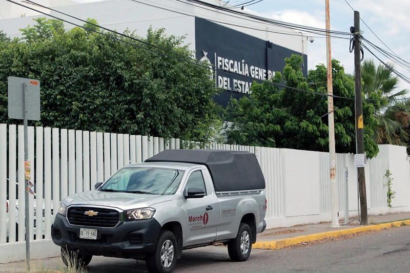 View of the Sinaloa State Attorney General's Office, where 20 bodies found on the "El Seminario" bridge were taken in Culiacan, Mexico, on June 30, 2025. Twenty bodies, several of them decapitated, were found on a highway bridge in a part of Mexico where factions of the Sinaloa drug cartel are fighting each other, authorities said Monday. Several headless corpses were found by the roadside, while 16 more bodies were discovered inside a vehicle abandoned at the scene, the Sinaloa state prosecutor's office said. (Photo by Ivan MEDINA / AFP) (Photo by IVAN MEDINA/AFP via Getty Images)