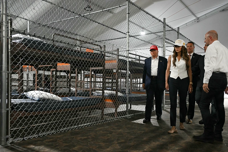 US President President Donald Trump (L), Florida Governor Ron DeSantis (2nd-R), and Secretary of Homeland Security Kristi Noem (2nd-L) tour a migrant detention center, dubbed "Alligator Alcatraz," located at the site of the Dade-Collier Training and Transition Airport in Ochopee, Florida on July 1, 2025. President Trump is visiting a migrant detention center in a reptile-infested Florida swamp dubbed "Alligator Alcatraz." Trump will attend the opening of the 5,000-bed facility -- located at an abandoned airfield in the Everglades wetlands -- part of his expansion of deportations of undocumented migrants, his spokeswoman said. (Photo by ANDREW CABALLERO-REYNOLDS / AFP) (Photo by ANDREW CABALLERO-REYNOLDS/AFP via Getty Images)