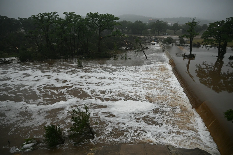 A photo shows flooding caused by a flash flood at the Guadalupe River in Kerrville, Texas, on July 5, 2025. Rescuers were desperately searching for at least 20 girls missing from a riverside summer camp, officials said on July 5, after torrential rains caused a "catastrophic" flash flood that killed at least 24 people as it swept through south-central Texas. (Photo by RONALDO SCHEMIDT / AFP) (Photo by RONALDO SCHEMIDT/AFP via Getty Images)