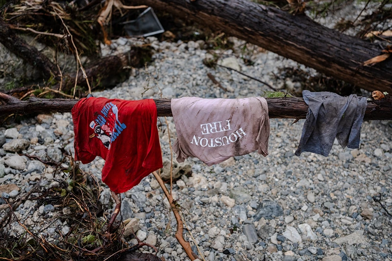 HUNT, TEXAS - JULY 6: Children's clothes hang on the branch of a tree on the bank of the Guadalupe River near Camp Mystic on July 6, 2025 in Hunt, Texas. Heavy rainfall caused flooding along the Guadalupe River in central Texas with multiple fatalities reported. (Photo by Jim Vondruska/Getty Images)