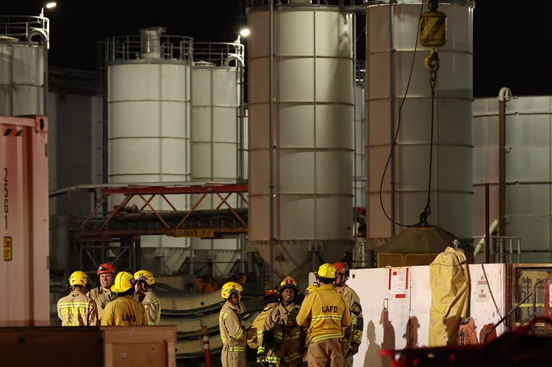 Los Angeles Fire Department (LAFD) firefighters are seen at the site of an industrial tunnel collapse in the Wilmington neighborhood of Los Angeles on July 9, 2025. 31 workers were safely removed from the tunnel without visible injuries, the LAFD said on July 9. (Photo by Patrick T. Fallon / AFP) (Photo by PATRICK T. FALLON/AFP via Getty Images)