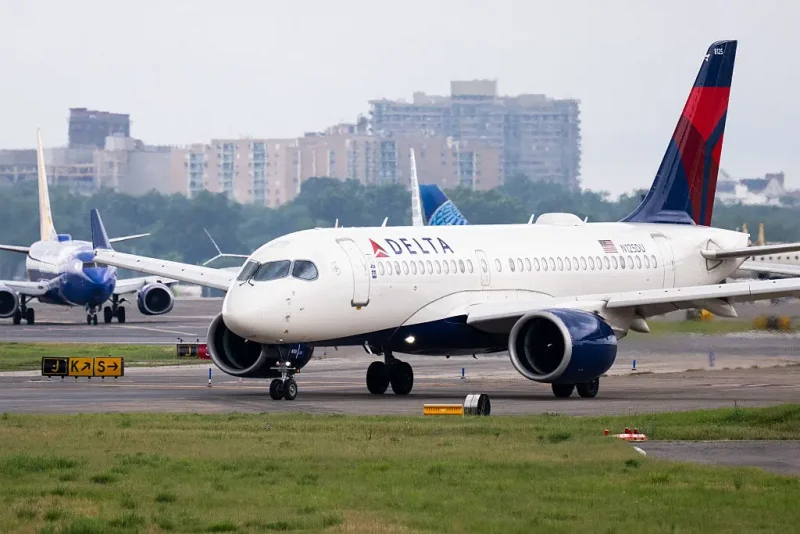 A Delta Air Lines Airbus A220 airplane prepares to takeoff at Ronald Reagan Washington National Airport in Arlington, Virginia, on July 10, 2025. Delta Air Lines stock shares surged more than 11 percent in early trading on Thursday, as the airline reported better-than-expected results. Between April and June, the group posted year-on-year sales of $16.65 billion and net income of $2.13 billion (+63% year-on-year). (Photo by SAUL LOEB / AFP) (Photo by SAUL LOEB/AFP via Getty Images)