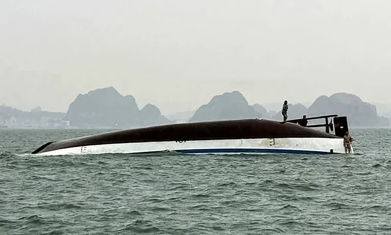 A man stands on a tourist boat that capsized in Ha Long Bay, Quang Ninh province on July 19, 2025. At least 18 people have died and dozens remain missing after a tourist boat carrying more than 50 people capsized on July 19, in Vietnam's Ha Long Bay, state media said. (Photo by AFP) (Photo by -/AFP via Getty Images)