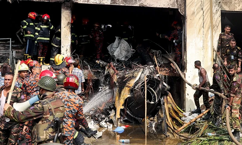Bangladesh's fire service and security personnel conduct a search and rescue operation after an Air Force training jet crashed into school in Dhaka on July 21, 2025. At least 16 people, mostly students, were killed on July 21, when a training aircraft of the Bangladesh Air Force crashed into a school campus in the capital Dhaka, the government said. (Photo by Abdul Goni / AFP) (Photo by ABDUL GONI/AFP via Getty Images)