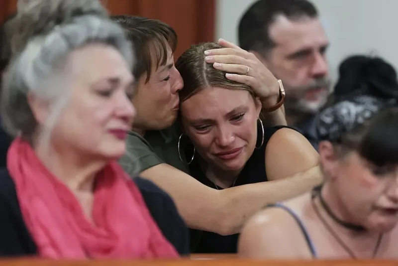 BOISE, IDAHO - JULY 23: Dylan Mortensen is comforted after speaking at the sentencing hearing of Bryan Kohberger at the Ada County Courthouse on July 23, 2025 in Boise, Idaho. Kohberger pleaded guilty in exchange for being spared the death penalty for the stabbing of four University of Idaho students nearly three years ago. He faces up to four life sentences in prison. (Photo by Kyle Green-Pool/Getty Images)