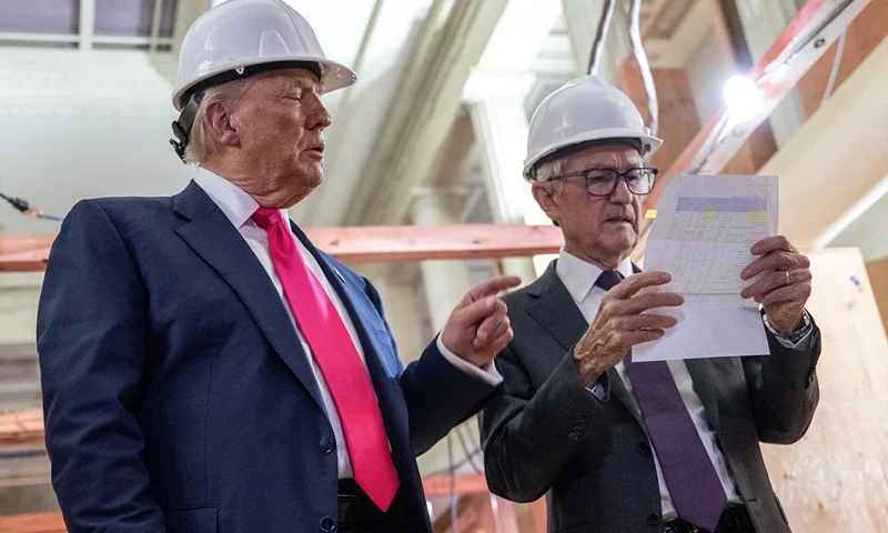 US President Donald Trump points to a cost sheet as he speaks with Federal Reserve chair Jerome Powell (R) as he visits the Federal Reserve in Washington, DC, on July 24, 2025. Trump arrived for a tour of the US Federal Reserve as the president escalates pressure on its chairman Jerome Powell over the central bank's management of the economy. Trump -- who wants to oust Powell for refusing to lower interest rates but likely lacks the legal authority -- has threatened to fire the Fed chief over cost overruns for a renovation of its Washington headquarters. (Photo by ANDREW CABALLERO-REYNOLDS / AFP) (Photo by ANDREW CABALLERO-REYNOLDS/AFP via Getty Images)