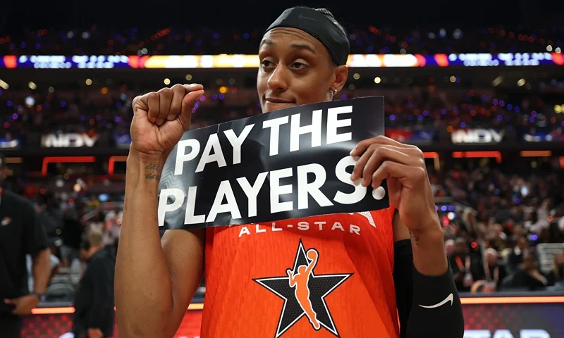 INDIANAPOLIS, INDIANA - JULY 19: Brittney Sykes #15 of the Washington Mystics holds a "Pay the Players" sign following the 2025 AT&T WNBA All-Star Game at Gainbridge Fieldhouse on July 19, 2025 in Indianapolis, Indiana. NOTE TO USER: User expressly acknowledges and agrees that, by downloading and or using this photograph, User is consenting to the terms and conditions of the Getty Images License Agreement. (Photo by Steph Chambers/Getty Images)