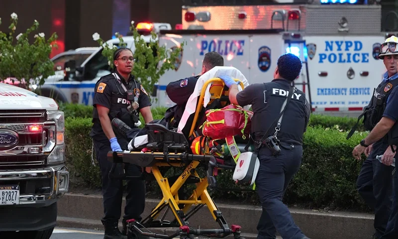 FDNY firefighters wheel a police officer on a gurney as police respond to an incident in the Midtown Manhattan neighborhood of New York on July 28, 2025. Police are investigating an "active shooter" incident, New York Mayor Eric Adams said on X (formerly Twitter) with the NYPD advising residents to "avoid the vicinity of East 52 Street between Park Avenue and Lexington Avenue". (Photo by TIMOTHY A. CLARY / AFP) (Photo by TIMOTHY A. CLARY/AFP via Getty Images)
