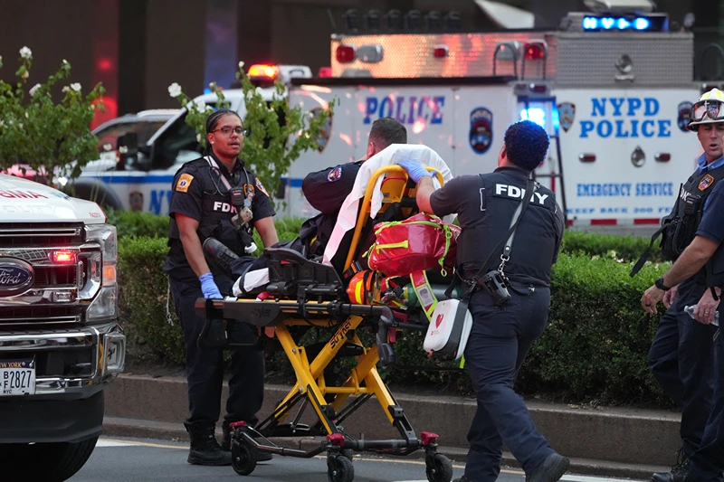 FDNY firefighters wheel a police officer on a gurney as police respond to an incident in the Midtown Manhattan neighborhood of New York on July 28, 2025. Police are investigating an "active shooter" incident, New York Mayor Eric Adams said on X (formerly Twitter) with the NYPD advising residents to "avoid the vicinity of East 52 Street between Park Avenue and Lexington Avenue". (Photo by TIMOTHY A. CLARY / AFP) (Photo by TIMOTHY A. CLARY/AFP via Getty Images)