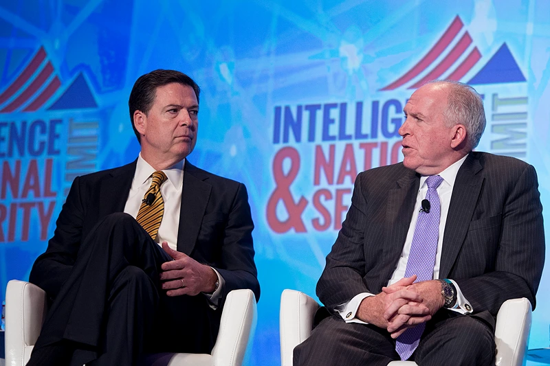 Federal Bureau of Investigation (FBI) Director James Comey (L) and Central Intelligence Agency (CIA) Director John Brennan speak at the 2016 Intelligence and National Security Summit in Washington, DC, September 8, 2016. / AFP / JIM WATSON (Photo credit should read JIM WATSON/AFP via Getty Images)