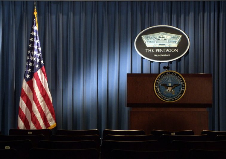 399192 06: The Pentagon logo and an American flag are lit up January 3, 2002 in the briefing room of Pentagon in Arlington, VA. (Photo by Alex Wong/Getty Images)