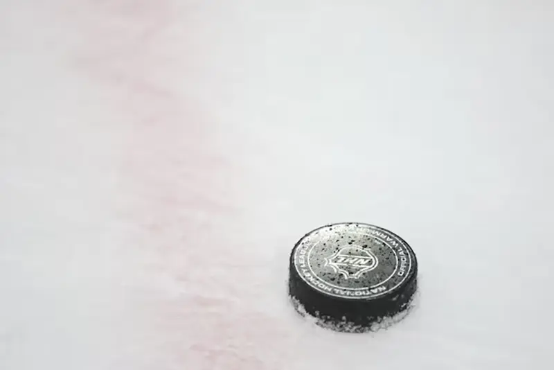 An National Hockey League puck is seen on the ice during warmups prior to a game between the Chicago Blackhawks and the Vegas Golden Knights at United Center. Mandatory Credit: Talia Sprague-Imagn Images/File Photo