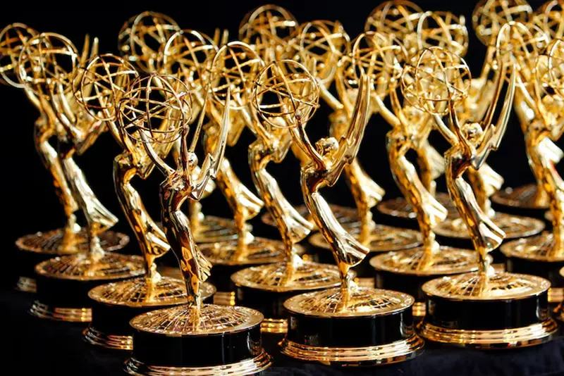 Dozens of Emmy Awards are lined up on the trophy table in the media center at the annual Primetime Emmy Awards in Los Angeles, California August 29, 2010. REUTERS/Danny Moloshok/File Photo