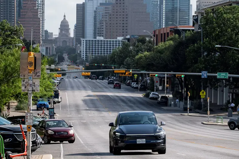 A Tesla robotaxi drives on the street along South Congress Avenue in Austin, Texas, U.S., June 22, 2025. REUTERS/Joel Angel Juarez/File Photo