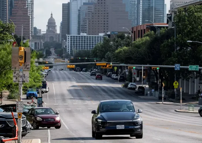 A Tesla robotaxi drives on the street along South Congress Avenue in Austin, Texas, U.S., June 22, 2025. REUTERS/Joel Angel Juarez/File Photo