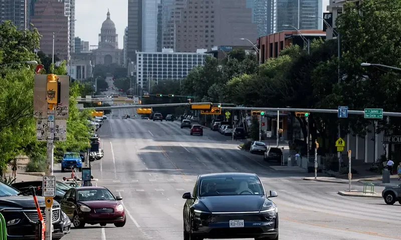 A Tesla robotaxi drives on the street along South Congress Avenue in Austin, Texas, U.S., June 22, 2025. REUTERS/Joel Angel Juarez/File Photo