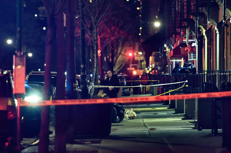 A general view shows the taped off area marking the scene of a shooting in Harlem, New York on January 22, 2022. - New York's mayor called on the federal government to help "stop the flow of weapons" in the city after a police officer was killed and another wounded in a shooting. (Photo by Ed JONES / AFP) (Photo by ED JONES/AFP via Getty Images)