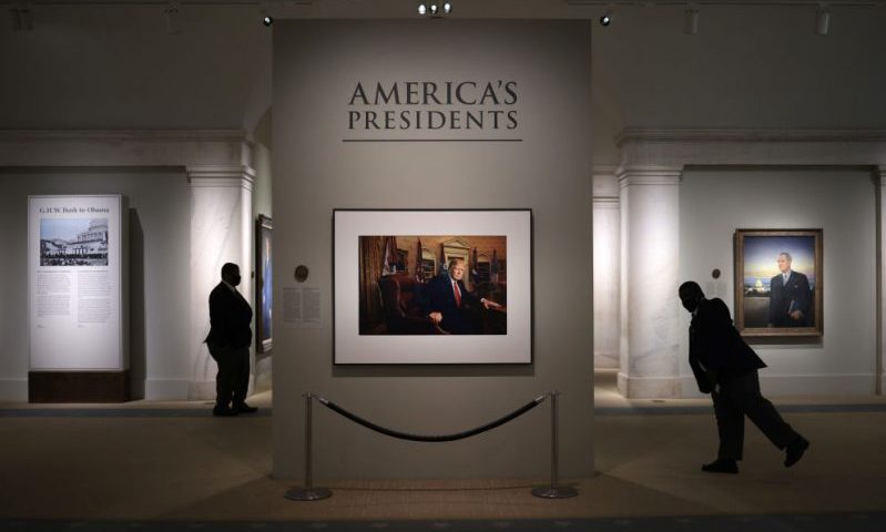 WASHINGTON, DC - MAY 14: Patrons and security guards view a portrait of former U.S. President Donald Trump in the America’s Presidents exhibition at the National Portrait Gallery as the Smithsonian Institution begins to slowly re-open its museums May 14, 2021 in Washington, DC. Trump’s portrait, a photograph made by Pari Dukovic is on display to the public for the first time since the closure of the museums due to the coronavirus pandemic. (Photo by Win McNamee/Getty Images)