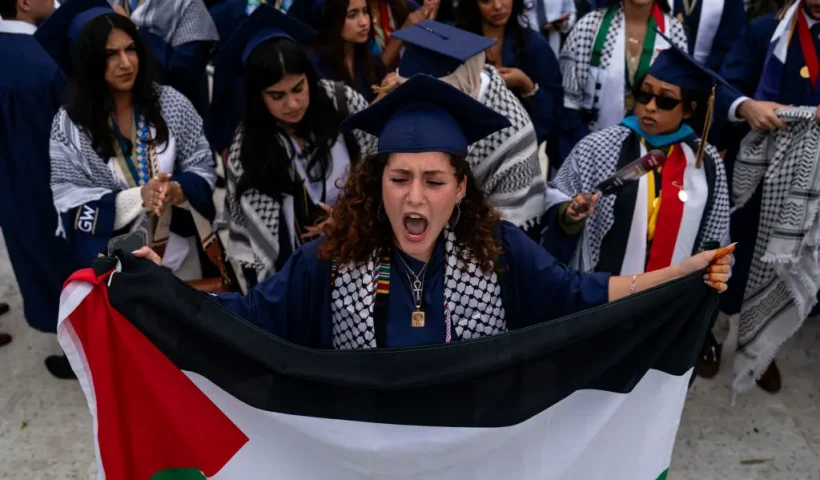 WASHINGTON, DC - MAY 19: Students protest as they walk out from the George Washington University (GWU) commencement ceremony as GWU President Ellen Granberg speaks on the National Mall on May 19, 2024 in Washington, DC. Student protests across university campuses have continued with walkouts occurring during commencement ceremonies as part of a coordinated effort to demand that institutions of higher education divest from companies and endowments with ties to Israel, amid Israel's continued siege of Gaza. (Photo by Kent Nishimura/Getty Images)