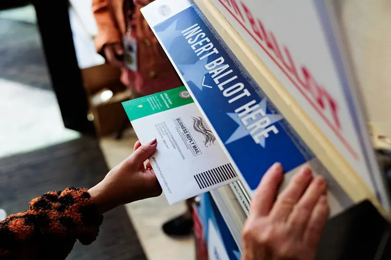 A person drops off a mail-in ballot on October 15, 2024 in Doylestown, Pennsylvania. Registered voters in Pennsylvania can vote "On Demand" by requesting, a mail-in or absentee ballot filing it out and dropping it off all in one visit to their county election office or other designated location. (Photo by Hannah Beier/Getty Images)