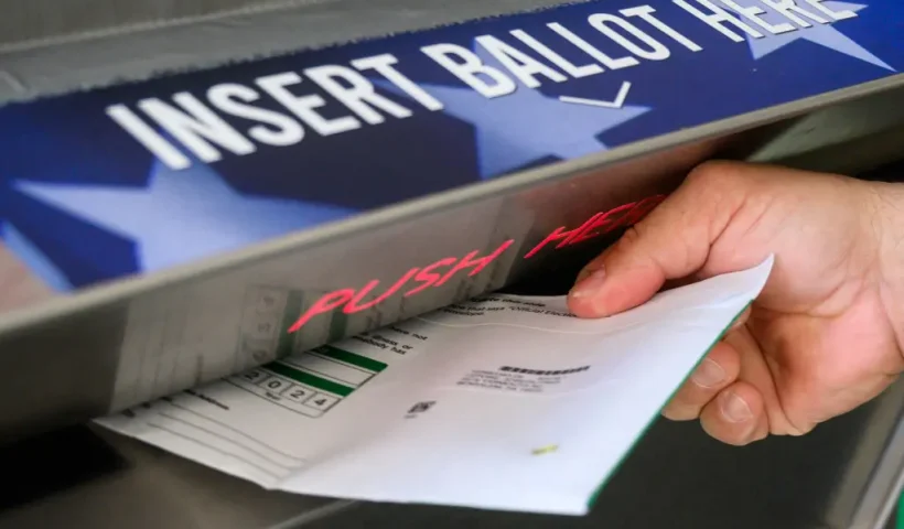 A voter uses a ballot drop box at the Bucks County Administration building voting on demand and ballot drop center in Doylestown, Pennsylvania on October 31, 2024. Kamala Harris clapped back Thursday at Donald Trump over what she called his "very offensive" remarks about women, returning reproductive rights to the fore as the rivals take their knife-edge White House race to western battleground states. (Photo by Ed JONES / AFP) (Photo by ED JONES/AFP via Getty Images)