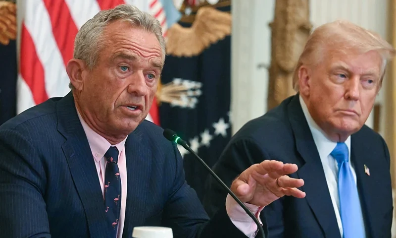 US President Donald Trump (R) listens as US Secretary of Health and Human Services Robert F. Kennedy Jr. speaks at an event on "Making Health Technology Great Again," in the East Room of the White House in Washington, DC on July 30, 2025. (Photo by Jim WATSON / AFP) (Photo by JIM WATSON/AFP via Getty Images)