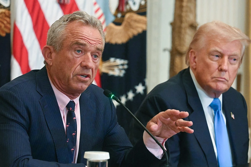 US President Donald Trump (R) listens as US Secretary of Health and Human Services Robert F. Kennedy Jr. speaks at an event on "Making Health Technology Great Again," in the East Room of the White House in Washington, DC on July 30, 2025. (Photo by Jim WATSON / AFP) (Photo by JIM WATSON/AFP via Getty Images)