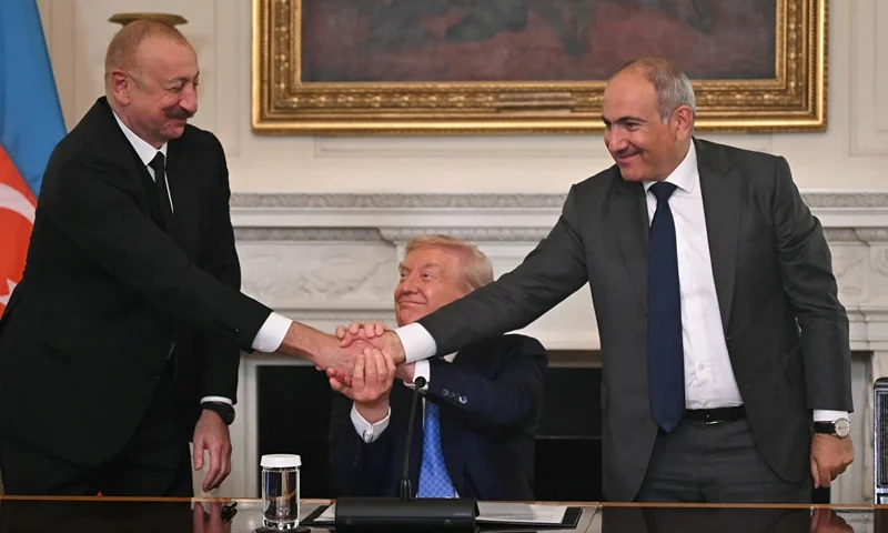US President Donald Trump (C), Azerbaijani President Ilham Aliyev (L) and Armenian Prime Minister Nikol Pashinyan shake hands after signing an agreement in the State Dining Room of the White House in Washington, DC, on August 8, 2025. US President Donald Trump said Friday that Armenia and Azerbaijan were committed to a permanent peace as he hosted a White House summit with the leaders of the two South Caucasus nations, which have fought for decades. (Photo by ANDREW CABALLERO-REYNOLDS / AFP) (Photo by ANDREW CABALLERO-REYNOLDS/AFP via Getty Images)