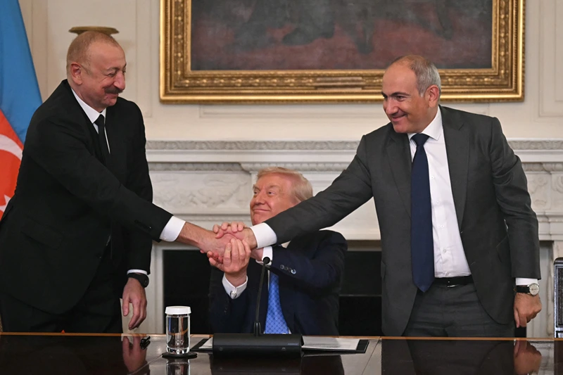 US President Donald Trump (C), Azerbaijani President Ilham Aliyev (L) and Armenian Prime Minister Nikol Pashinyan shake hands after signing an agreement in the State Dining Room of the White House in Washington, DC, on August 8, 2025. US President Donald Trump said Friday that Armenia and Azerbaijan were committed to a permanent peace as he hosted a White House summit with the leaders of the two South Caucasus nations, which have fought for decades. (Photo by ANDREW CABALLERO-REYNOLDS / AFP) (Photo by ANDREW CABALLERO-REYNOLDS/AFP via Getty Images)