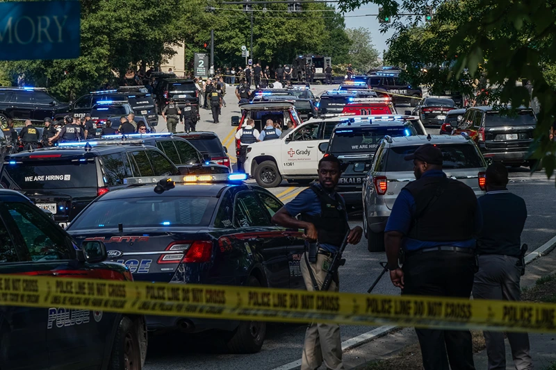 : Law enforcement is seen near the Centers For Disease Control (CDC) Global Headquarters during an active shooter incident on August 8, 2025 in Atlanta, Georgia. According to the Atlanta Police Department, the suspect in the active shooter situation is dead and a police officer was injured. (Photo by Elijah Nouvelage/Getty Images)