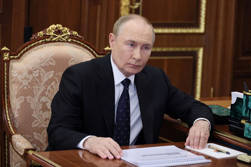 In this pool photograph distributed by the Russian state agency Sputnik, Russia's President Vladimir Putin (L) meets with the Head of the Federal Tax Service (FTS) in Moscow on August 13, 2025. (Photo by Vyacheslav PROKOFYEV / POOL / AFP) (Photo by VYACHESLAV PROKOFYEV/POOL/AFP via Getty Images)