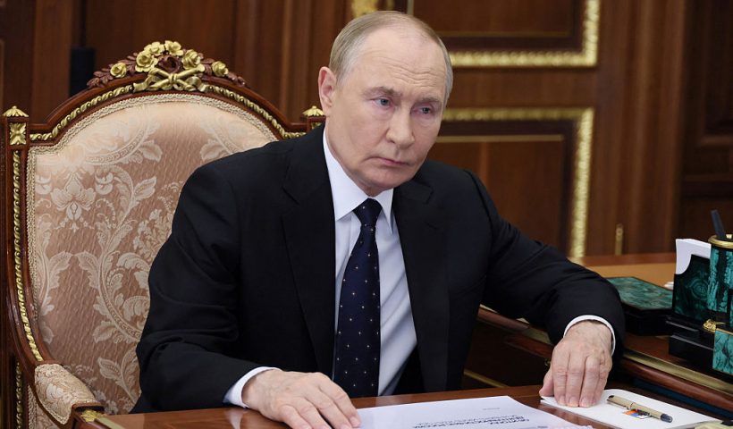In this pool photograph distributed by the Russian state agency Sputnik, Russia's President Vladimir Putin (L) meets with the Head of the Federal Tax Service (FTS) in Moscow on August 13, 2025. (Photo by Vyacheslav PROKOFYEV / POOL / AFP) (Photo by VYACHESLAV PROKOFYEV/POOL/AFP via Getty Images)