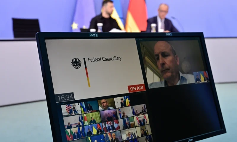 Ukrainian President Volodymyr Zelensky (back L) and German Chancellor Friedrich Merz (back R) attend a video conference of European leaders with the US President on the Ukraine war ahead of the summit between the US and Russian leaders, on August 13, 2025. European leaders will hold online talks with US President Donald Trump, hoping to convince him to respect Ukraine's interests when he discusses the war with Putin in Alaska on Friday. (Photo by John MACDOUGALL / POOL / AFP) (Photo by JOHN MACDOUGALL/POOL/AFP via Getty Images)