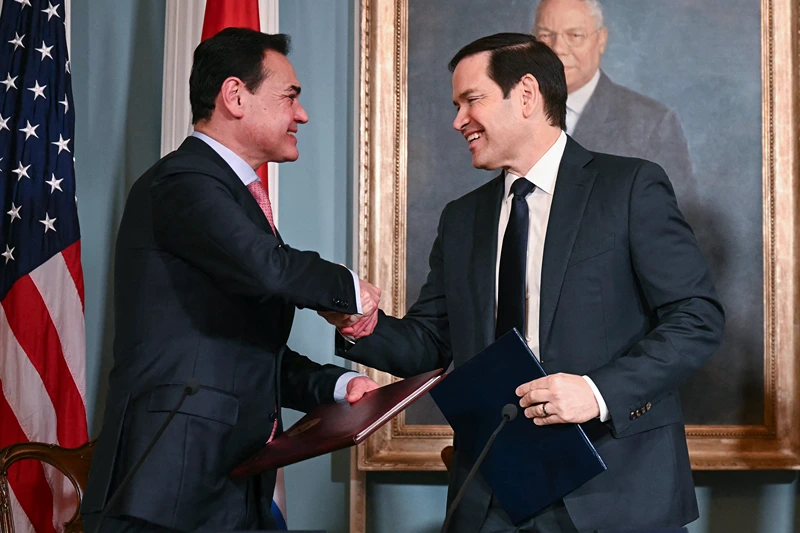 US Secretary of State Marco Rubio (C) and Foreign Minister of Paraguay Ruben Ramirez Lezcano (L) shake hands after signing a memorandum of understanding in the Treaty Room of the State Department in Washington, DC, on August 14, 2025. They are joined by US Deputy Secretary of Homeland Security Troy Edgar (R). (Photo by Jim WATSON / AFP) (Photo by JIM WATSON/AFP via Getty Images)