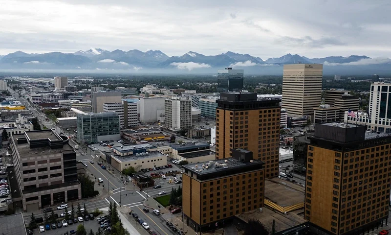 An aerial view of downtown Anchorage, Alaska, with the Chugach Mountains in the background, on August 14, 2025, ahead of the August 15 scheduled meeting between US President Donald Trump and Russian President Vladimir Putin. Trump on Thursday acknowledged his high-stakes summit with Vladimir Putin may fail, and said any Ukraine deal would come through a future three-way meeting with Kyiv to "divvy things up." Russian President Vladimir Putin flies to Alaska on Friday at the invitation of Trump in his first visit to a Western country since he ordered the 2022 invasion of Ukraine that has killed tens of thousands of people. (Photo by Drew ANGERER / AFP) (Photo by DREW ANGERER/AFP via Getty Images)
