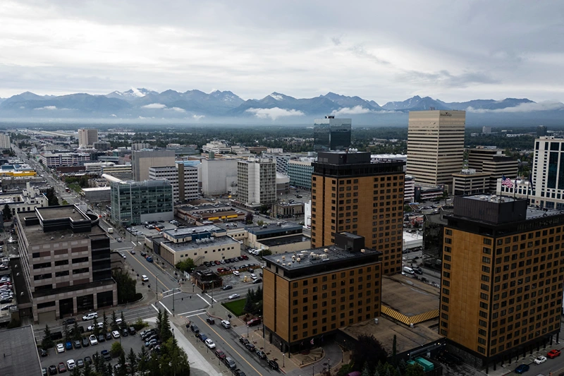 An aerial view of downtown Anchorage, Alaska, with the Chugach Mountains in the background, on August 14, 2025, ahead of the August 15 scheduled meeting between US President Donald Trump and Russian President Vladimir Putin. Trump on Thursday acknowledged his high-stakes summit with Vladimir Putin may fail, and said any Ukraine deal would come through a future three-way meeting with Kyiv to "divvy things up." Russian President Vladimir Putin flies to Alaska on Friday at the invitation of Trump in his first visit to a Western country since he ordered the 2022 invasion of Ukraine that has killed tens of thousands of people. (Photo by Drew ANGERER / AFP) (Photo by DREW ANGERER/AFP via Getty Images)