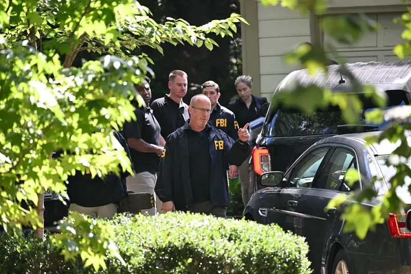 FBI agents are seen outside John Bolton's house, Donald Trump's former national security advisor after the FBI conducted a court-authorized search at his place on August 22, 2025 in Bethesda, Maryland. Federal Bureau of Investigation agents searched on Friday the home of John Bolton, Donald Trump's former national security advisor who has become a vocal critic of the US president. (Photo by SAUL LOEB / AFP) (Photo by SAUL LOEB/AFP via Getty Images)