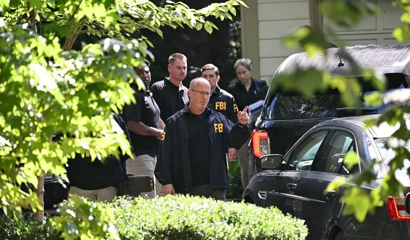 FBI agents are seen outside John Bolton's house, Donald Trump's former national security advisor after the FBI conducted a court-authorized search at his place on August 22, 2025 in Bethesda, Maryland. Federal Bureau of Investigation agents searched on Friday the home of John Bolton, Donald Trump's former national security advisor who has become a vocal critic of the US president. (Photo by SAUL LOEB / AFP) (Photo by SAUL LOEB/AFP via Getty Images)