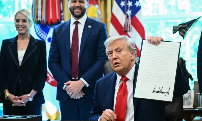 US President Donald Trump holds up an executive order he signed that aims to end cashless bail, in the Oval Office of the White House in Washington, DC on August 25, 2025. Also pictured, L/R, US Attorney General Pam Bondi and Vice President JD Vance. (Photo by Mandel NGAN / AFP) (Photo by MANDEL NGAN/AFP via Getty Images)