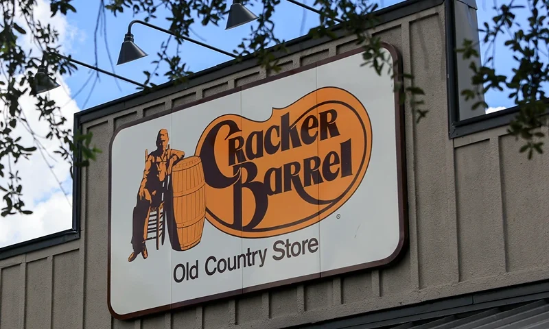 PEMBROKE PINES, FLORIDA - AUGUST 21: A Cracker Barrel sign featuring the old logo hangs on the outside of a restaurant on August 21, 2025 in Homestead, Florida. The restaurant unveiled a new logo earlier this week as part of a larger brand refresh. The new logo removes the image of a man sitting next to a barrel and the phrase “old country store”. Now the logo will feature the words “Cracker Barrel” against a yellow background. (Photo by Joe Raedle/Getty Images)