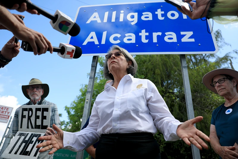 OCHOPEE, FLORIDA - AUGUST 22: Miami-Dade County Mayor Daniella Levine Cava speaks to the media at the entrance to "Alligator Alcatraz" at the Dade-Collier Training and Transition Airport on August 22, 2025 in Ochopee, Florida. The mayor spoke about her support for a decision by a federal judge that ordered an indefinite halt to new construction at the immigration detention facility, and barred any new detainees from being brought to the site, siding with environmental groups who said the facility is endangering the Everglades and its wildlife. The state of Florida filed notice of appeal after the judge's ruling. (Photo by Joe Raedle/Getty Images)