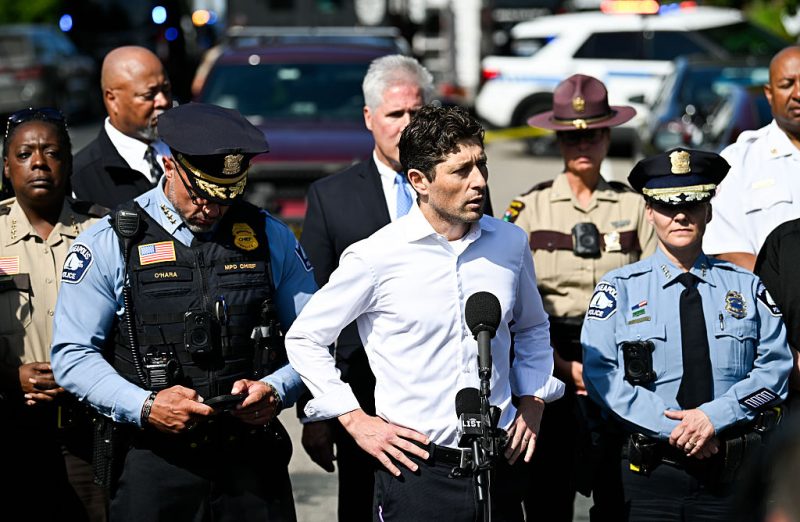 MINNEAPOLIS, MINNESOTA - AUGUST 27: Minneapolis Mayor Jacob Frey (C) speaks to the media following a mass shooting at Annunciation Catholic School on August 27, 2025 in Minneapolis, Minnesota. According to Minneapolis Police, a gunman fired through the windows of the Annunciation Church at worshippers sitting in pews during a Catholic school Mass, killing two children and injuring at least 17 others. The gunman reportedly died at the scene from a self-inflicted gunshot wound. (Photo by Stephen Maturen/Getty Images)