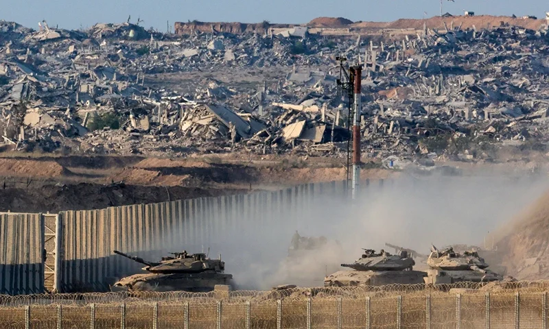 TOPSHOT - Israeli army main battle tanks move along the border with the Gaza Strip in southern Israel on August 27, 2025. Israeli military pressed operations around Gaza City on August 27, as President Donald Trump prepared to host a White House meeting on post-war plans for the shattered Palestinian territory. (Photo by Jack GUEZ / AFP) (Photo by JACK GUEZ/AFP via Getty Images)