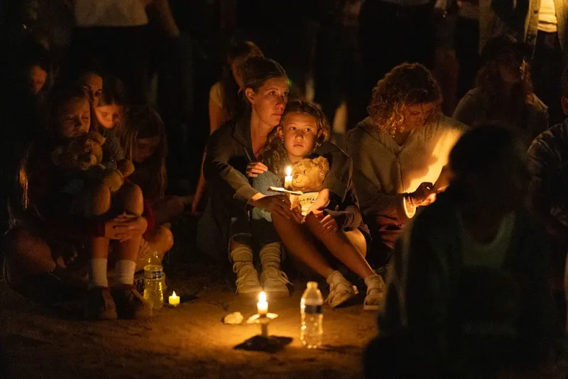 MINNEAPOLIS, MINNESOTA - AUGUST 27: People attend a vigil at Lynnhurst Park to mourn the dead and pray for the wounded after a gunman opened fire on students at Annunciation Catholic School on August 27, 2025 in Minneapolis, Minnesota. According to Minneapolis Police, the gunman fired through the windows of the Annunciation Church while worshippers were sitting in pews during a Catholic school Mass, killing two children and injuring at least 17 others. The gunman died at the scene from a self-inflicted gunshot wound, according to police. (Photo by Scott Olson/Getty Images)