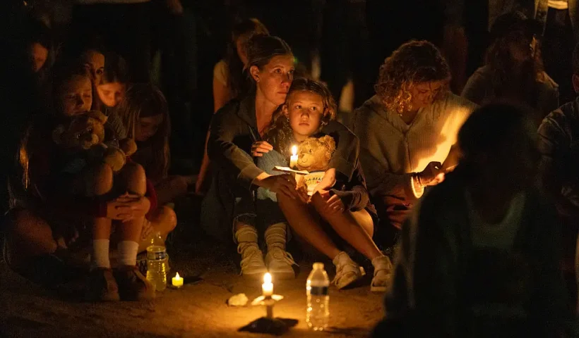 MINNEAPOLIS, MINNESOTA - AUGUST 27: People attend a vigil at Lynnhurst Park to mourn the dead and pray for the wounded after a gunman opened fire on students at Annunciation Catholic School on August 27, 2025 in Minneapolis, Minnesota. According to Minneapolis Police, the gunman fired through the windows of the Annunciation Church while worshippers were sitting in pews during a Catholic school Mass, killing two children and injuring at least 17 others. The gunman died at the scene from a self-inflicted gunshot wound, according to police. (Photo by Scott Olson/Getty Images)