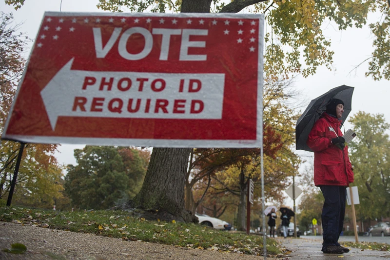 A volunteer for the Independent political party stands outside a polling station waiting to speak to voters in Arlington, Virginia on November 7, 2017. In New Jersey and Virginia, voters will elect a new governor, the latter seen as a big test for Trump. / AFP PHOTO / Andrew CABALLERO-REYNOLDS (Photo credit should read ANDREW CABALLERO-REYNOLDS/AFP via Getty Images)
